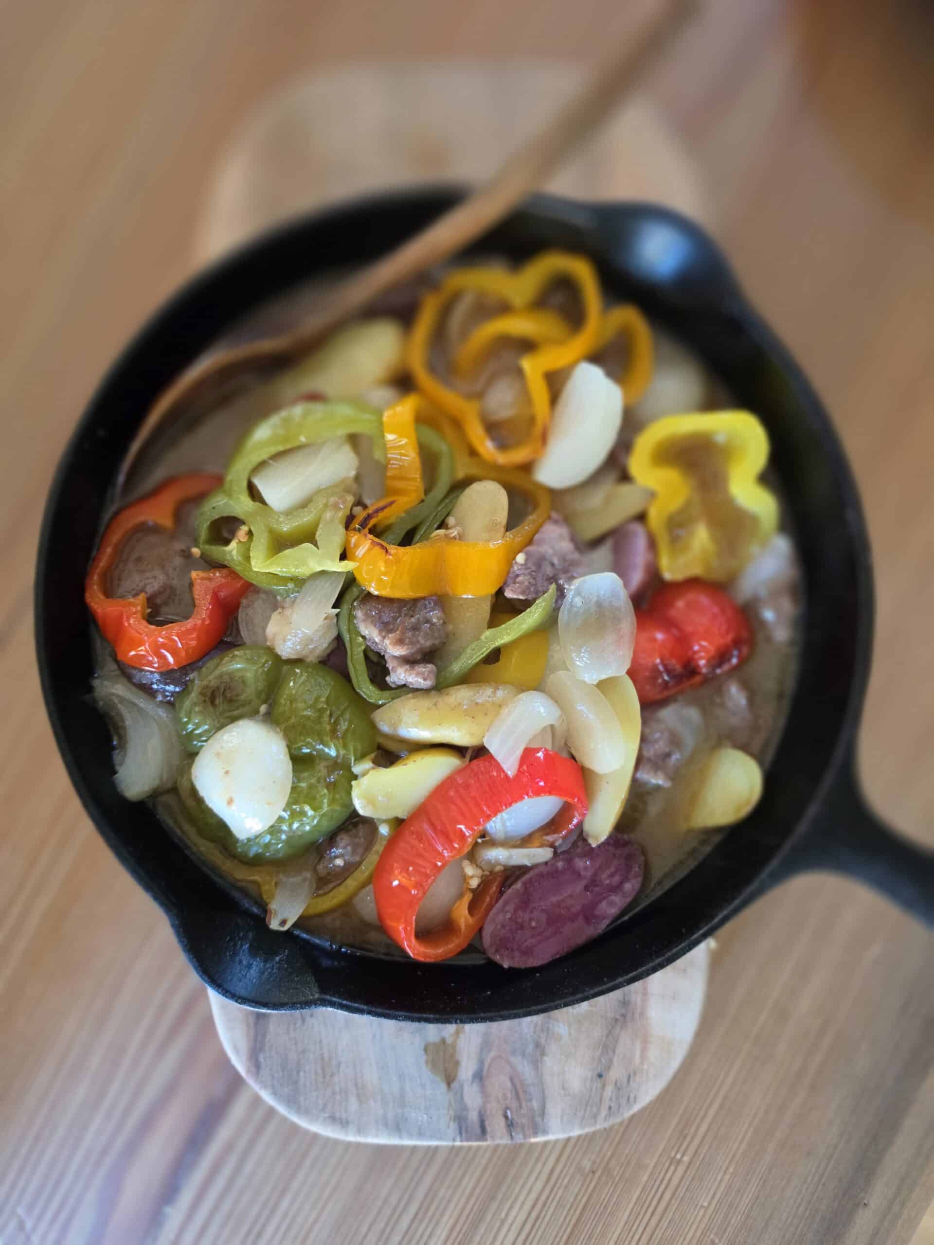 Beef and vegetable stew with bone broth in a cast iron skillet