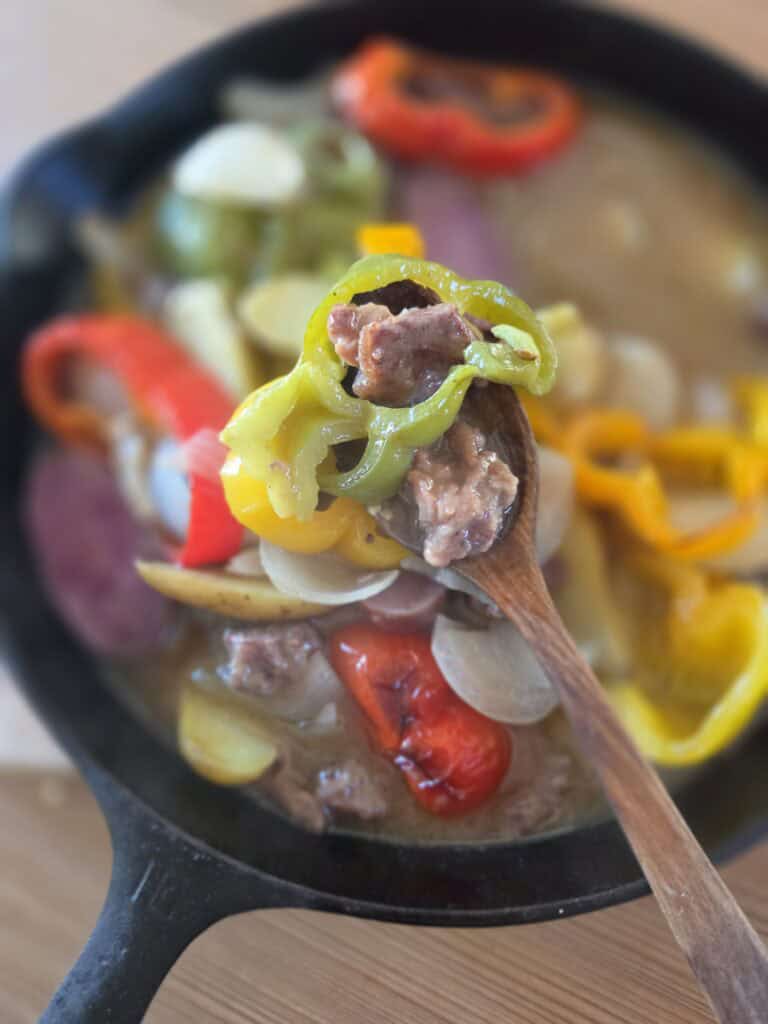 Beef and vegetable stew with bone broth in a cast iron skillet